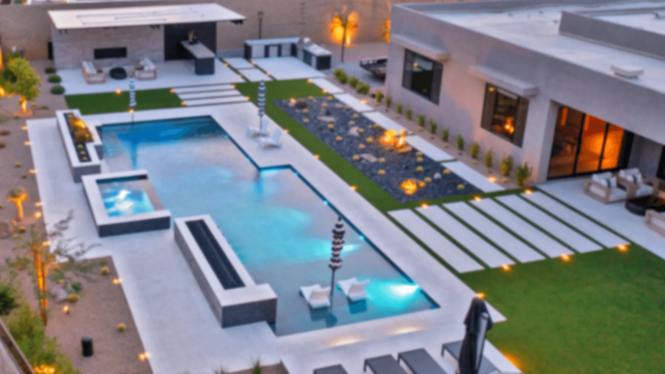 Aerial view of a custom Arizona backyard pool with spa, fire features, turf, and modern outdoor living areas
